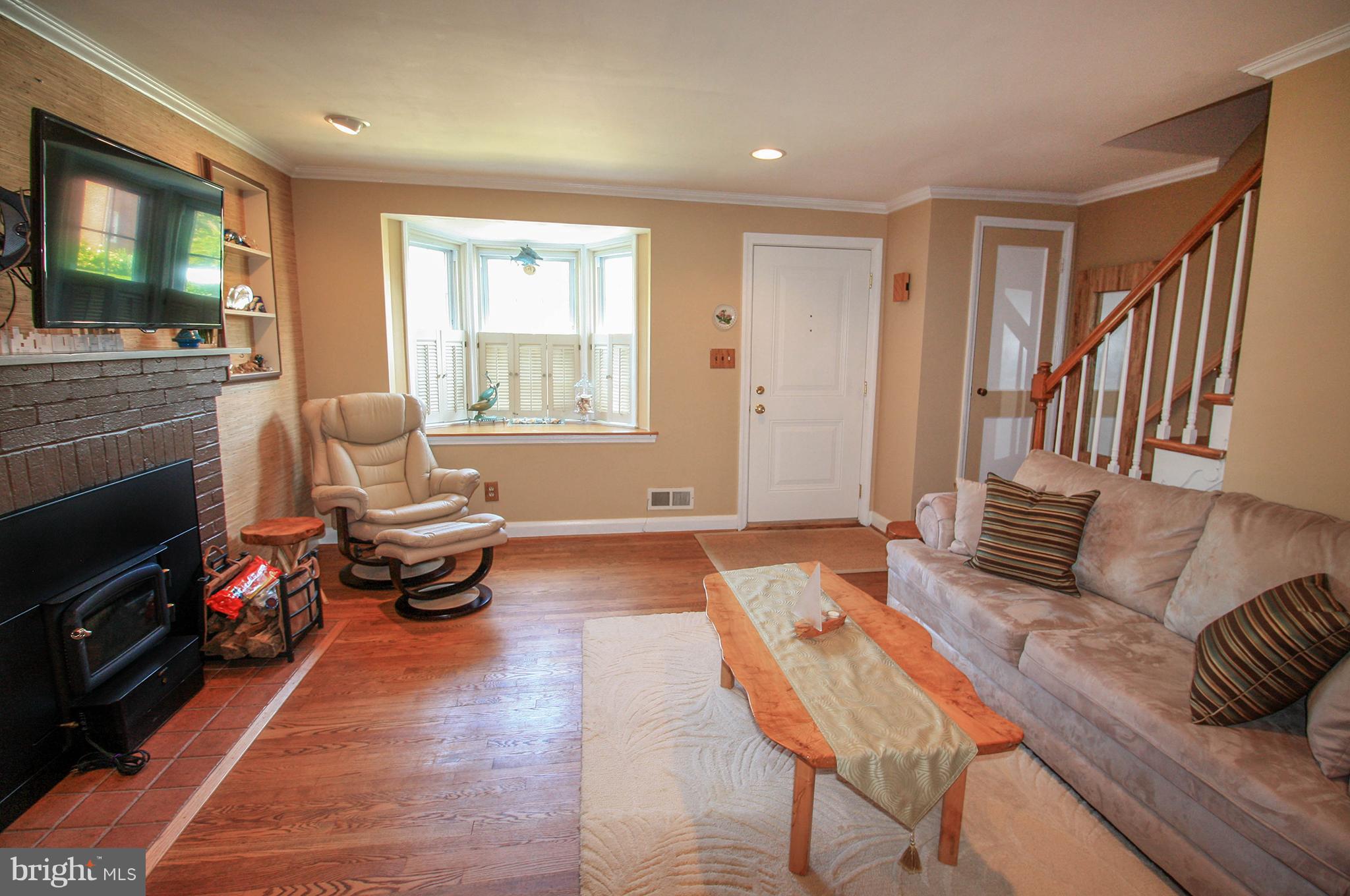 8427 Pleasant Plains Road Baltimore, MD 21286 - Photo 7 of 30 a living room with furniture and a fireplace