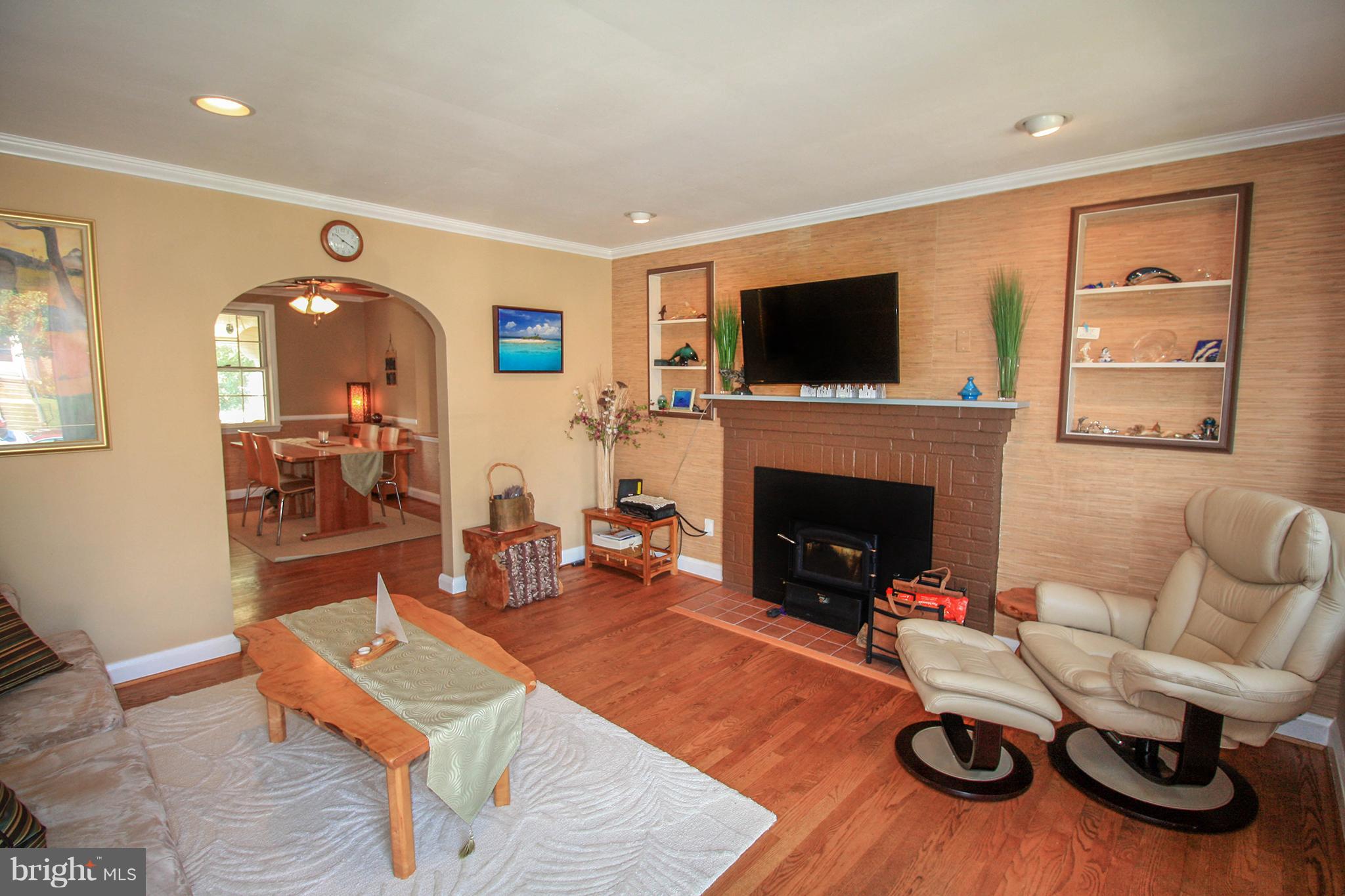 8427 Pleasant Plains Road Baltimore, MD 21286 - Photo 8 of 30 a living room with furniture fireplace and flat screen tv
