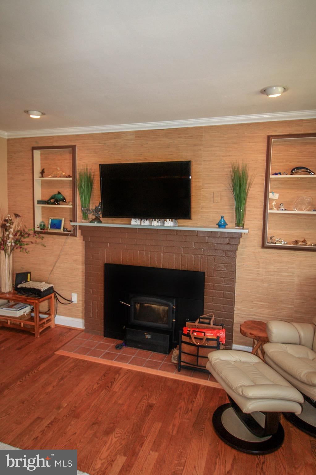 8427 Pleasant Plains Road Baltimore, MD 21286 - Photo 10 of 30 a living room with furniture a flat screen tv and a fireplace