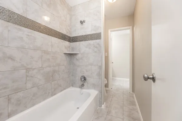 a bathroom with a bathtub and shower