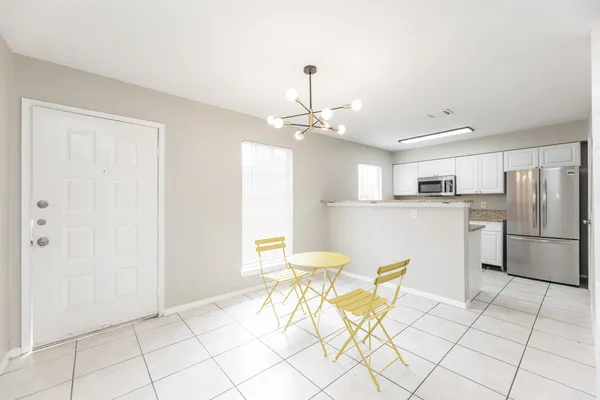 a kitchen with stainless steel appliances kitchen island granite countertop a refrigerator and a cabinets