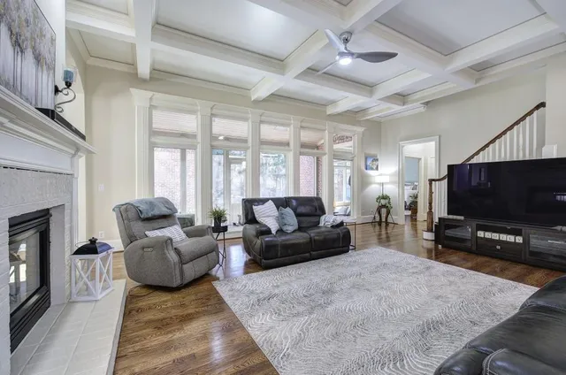 a kitchen with stainless steel appliances granite countertop a stove top oven a refrigerator a sink and a dining table with wooden floor