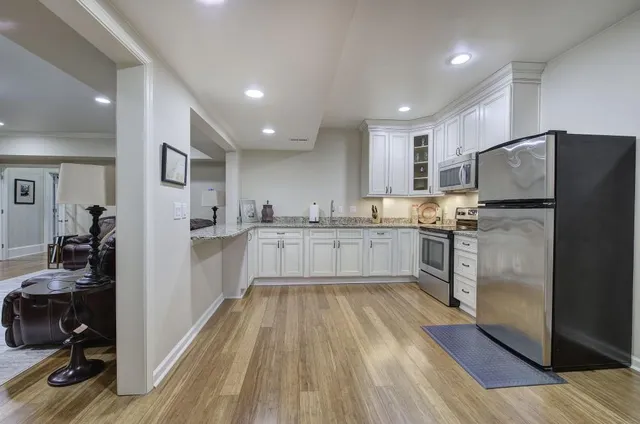 a view of a chair and table in backyard of the house