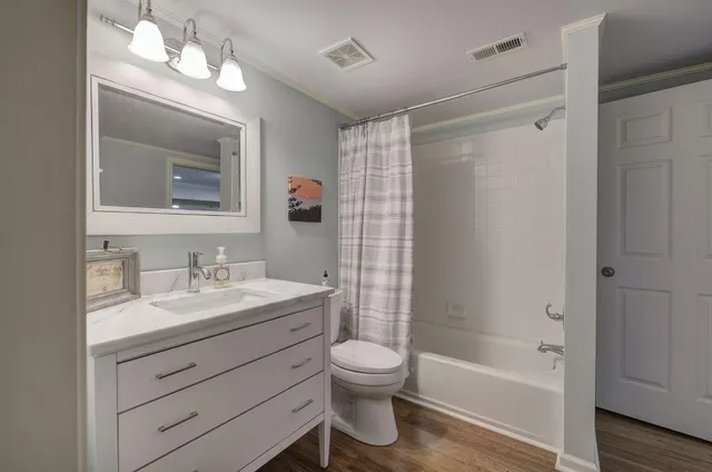 a bedroom with a bed window and a chandelier
