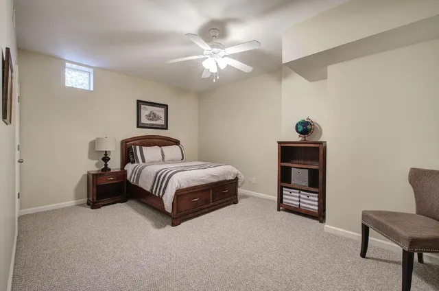 a bathroom with a granite countertop sink a toilet and shower