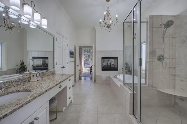 a living room with furniture fireplace and a chandelier