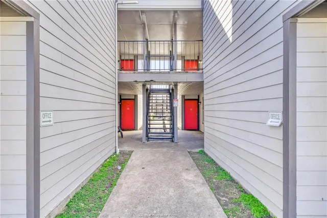 a view of a house with door and a yard