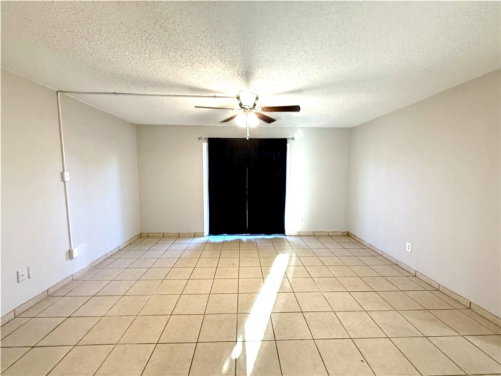 2000 Kazmeier, Unit 25 Bryan, TX 77802 - Photo 4 of 11 a view of an empty room and chandelier fan