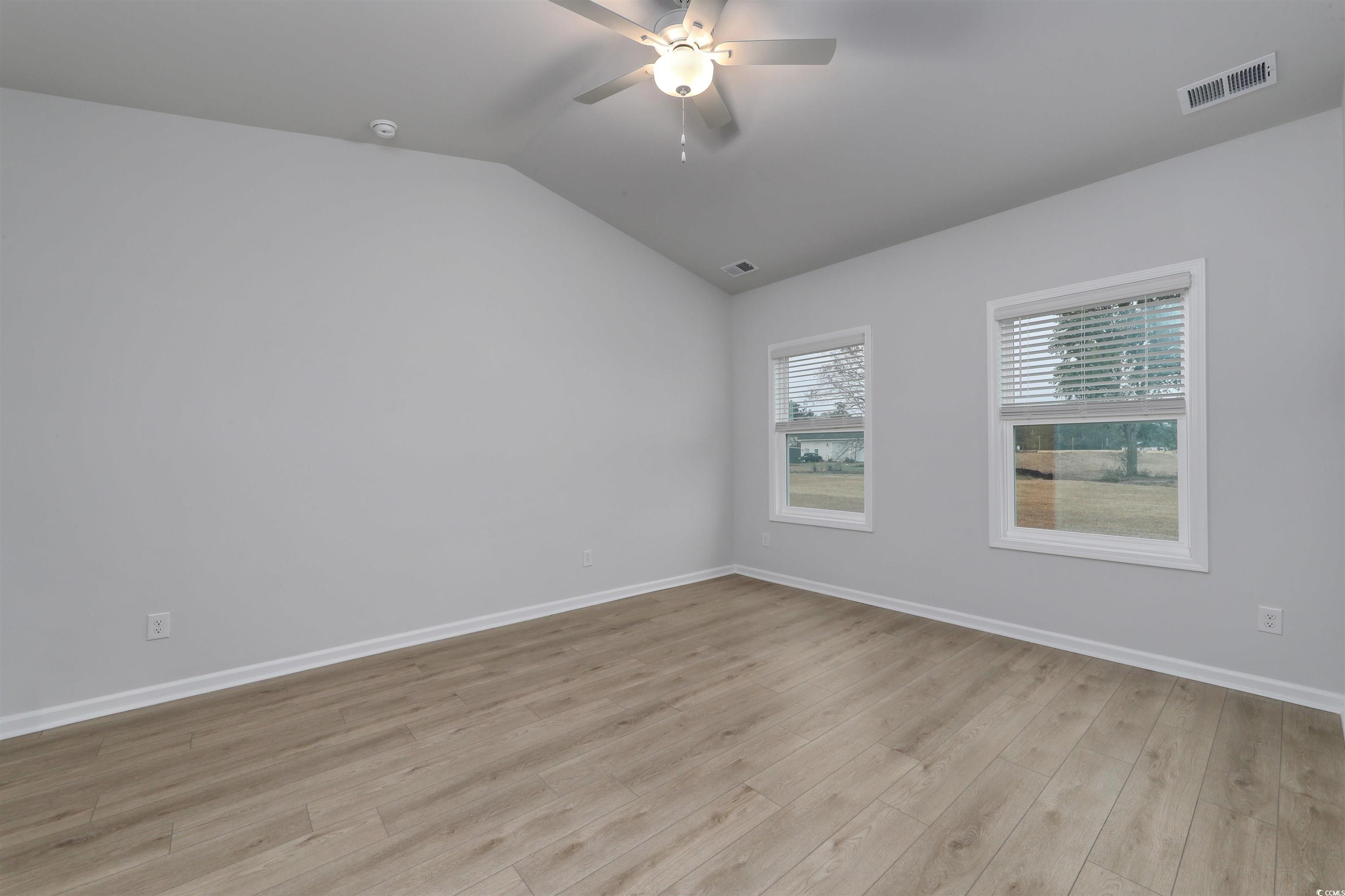 370 Garden Grove Street Conway, SC 29526 - Photo 13 of 28 Unfurnished room featuring lofted ceiling, light wood-style floors, and a ceiling fan