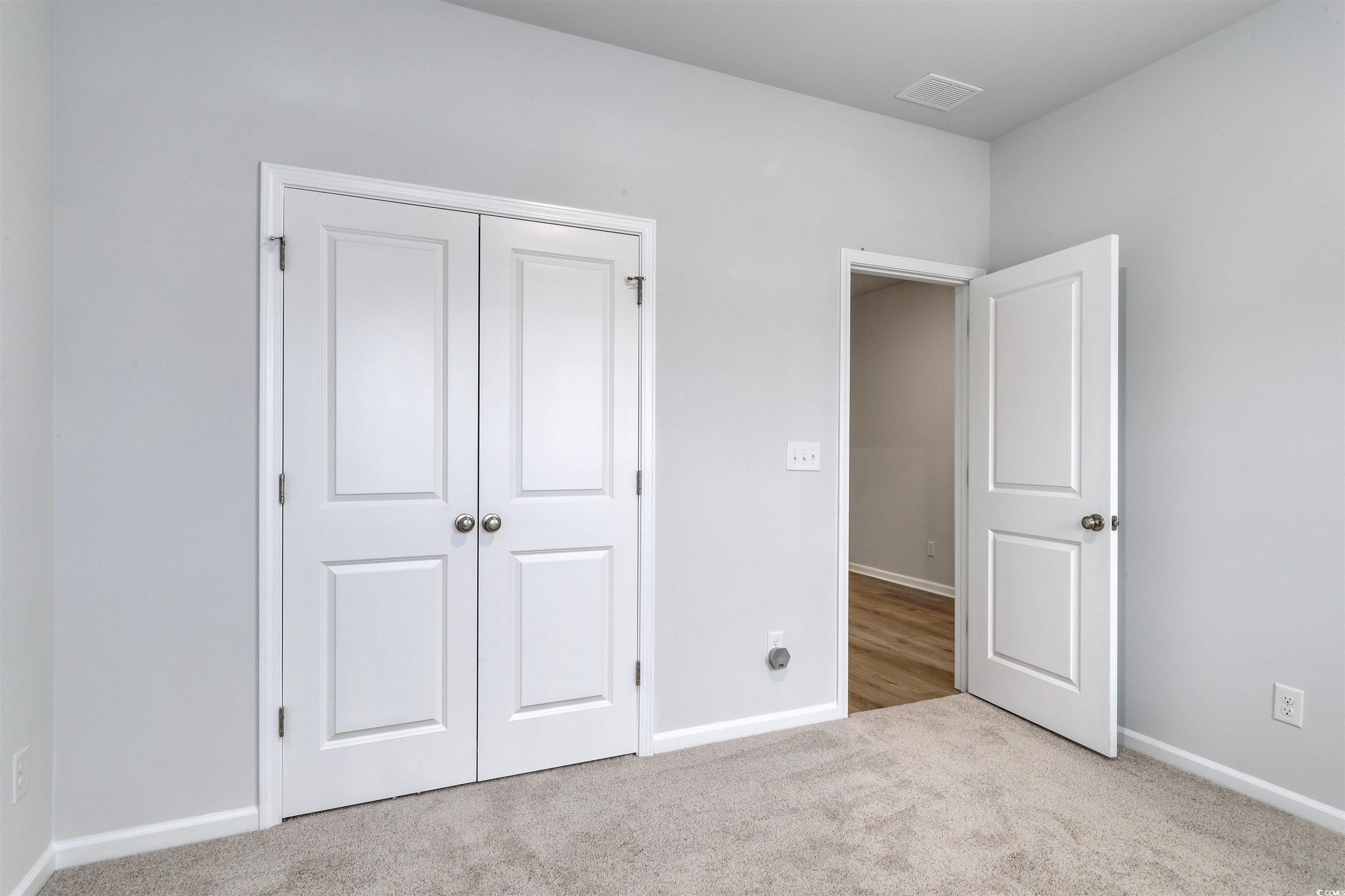 370 Garden Grove Street Conway, SC 29526 - Photo 22 of 28 Unfurnished bedroom with light colored carpet and a closet