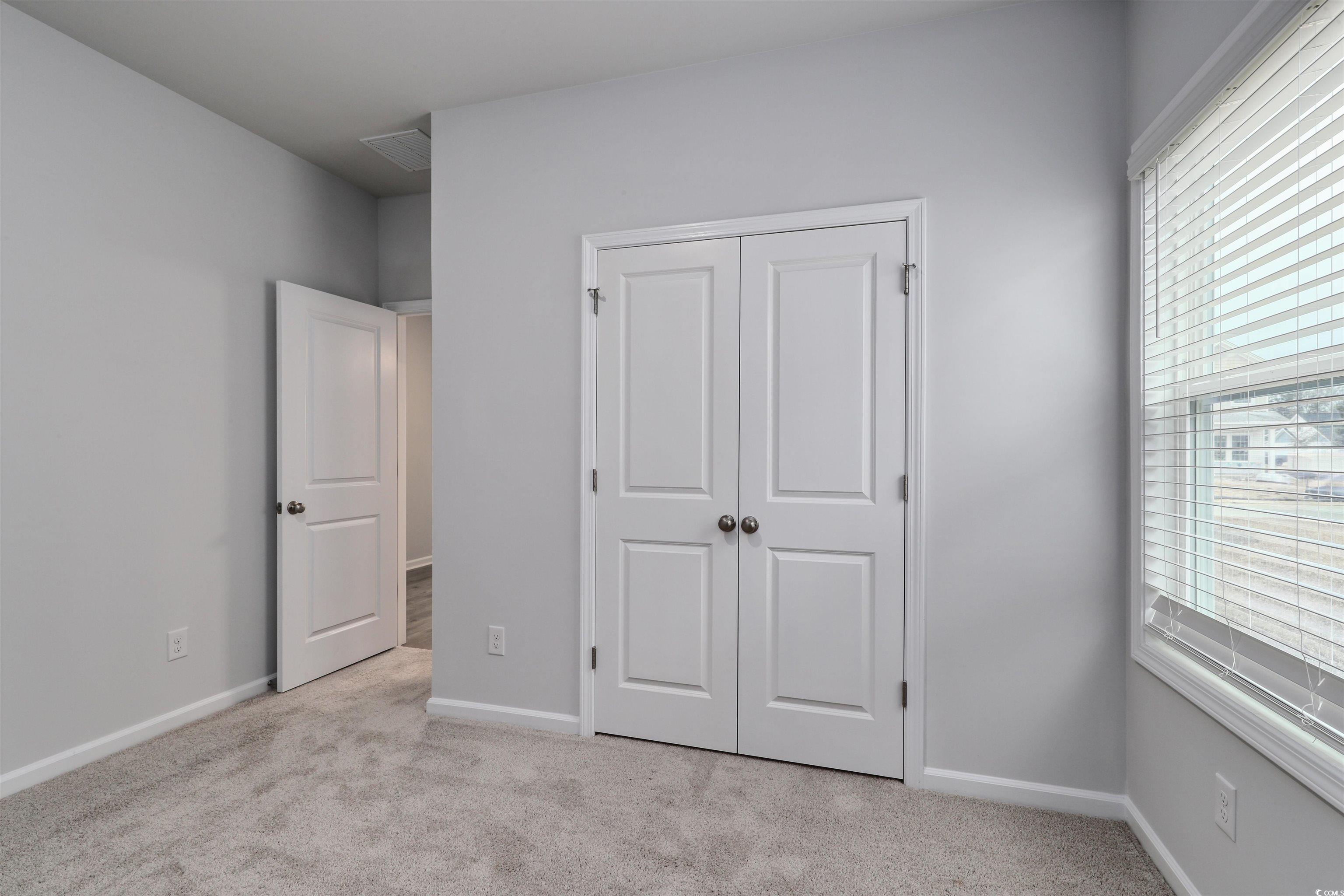 370 Garden Grove Street Conway, SC 29526 - Photo 24 of 28 Unfurnished bedroom featuring light colored carpet and a closet