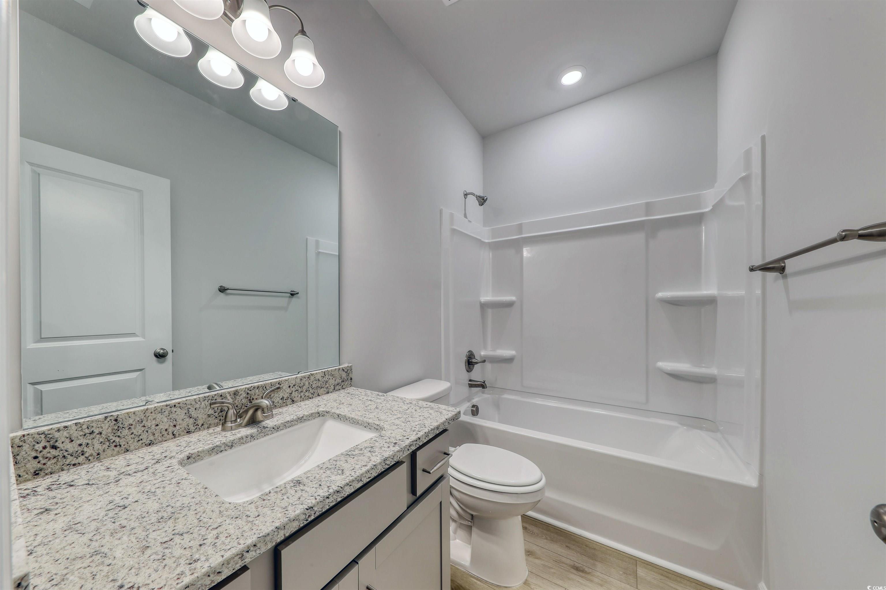 370 Garden Grove Street Conway, SC 29526 - Photo 25 of 28 Full bathroom featuring vanity, shower / bath combination, and light wood-style flooring