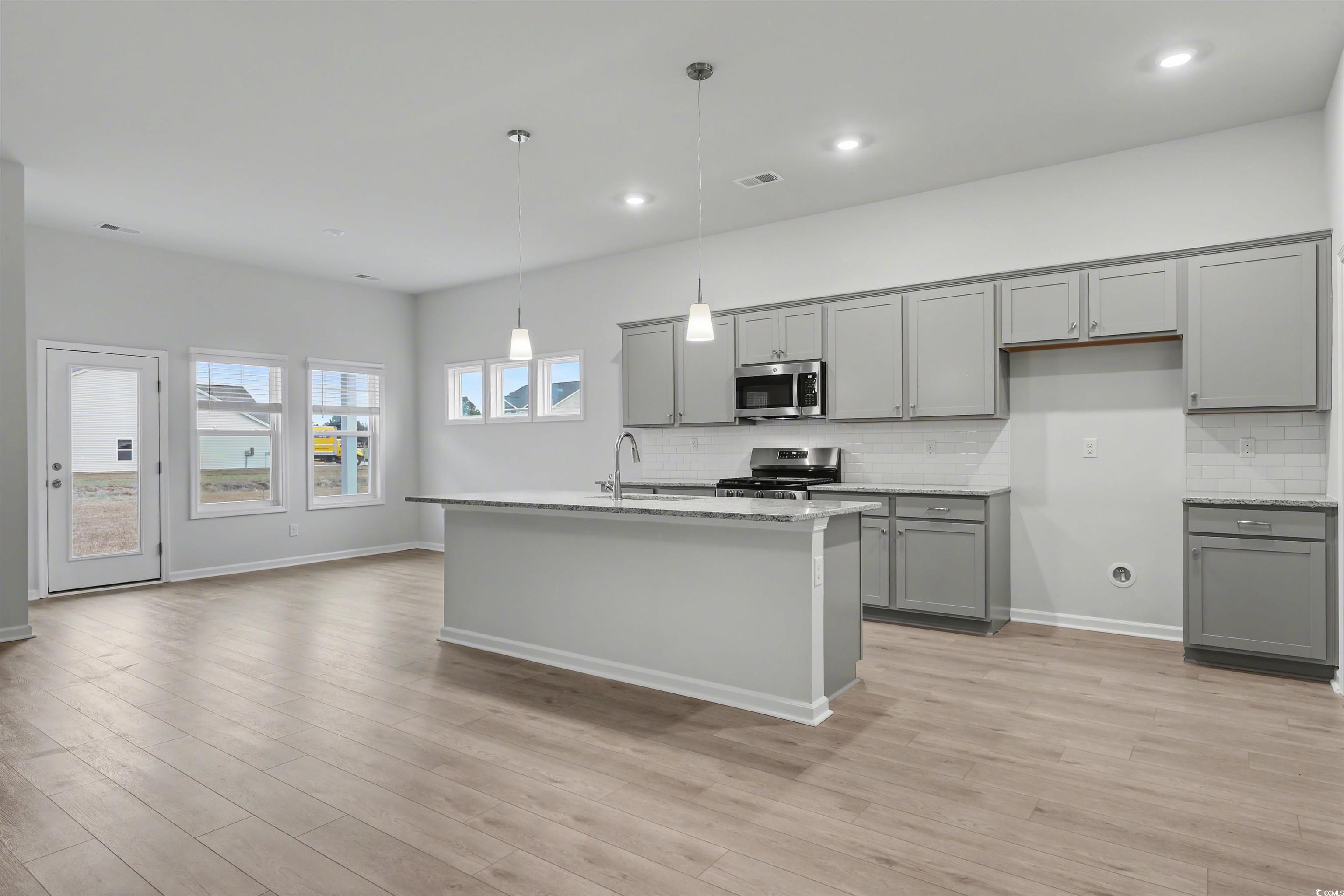 370 Garden Grove Street Conway, SC 29526 - Photo 4 of 28 Kitchen with gray cabinets, stainless steel appliances, an island with sink, backsplash, and recessed lighting