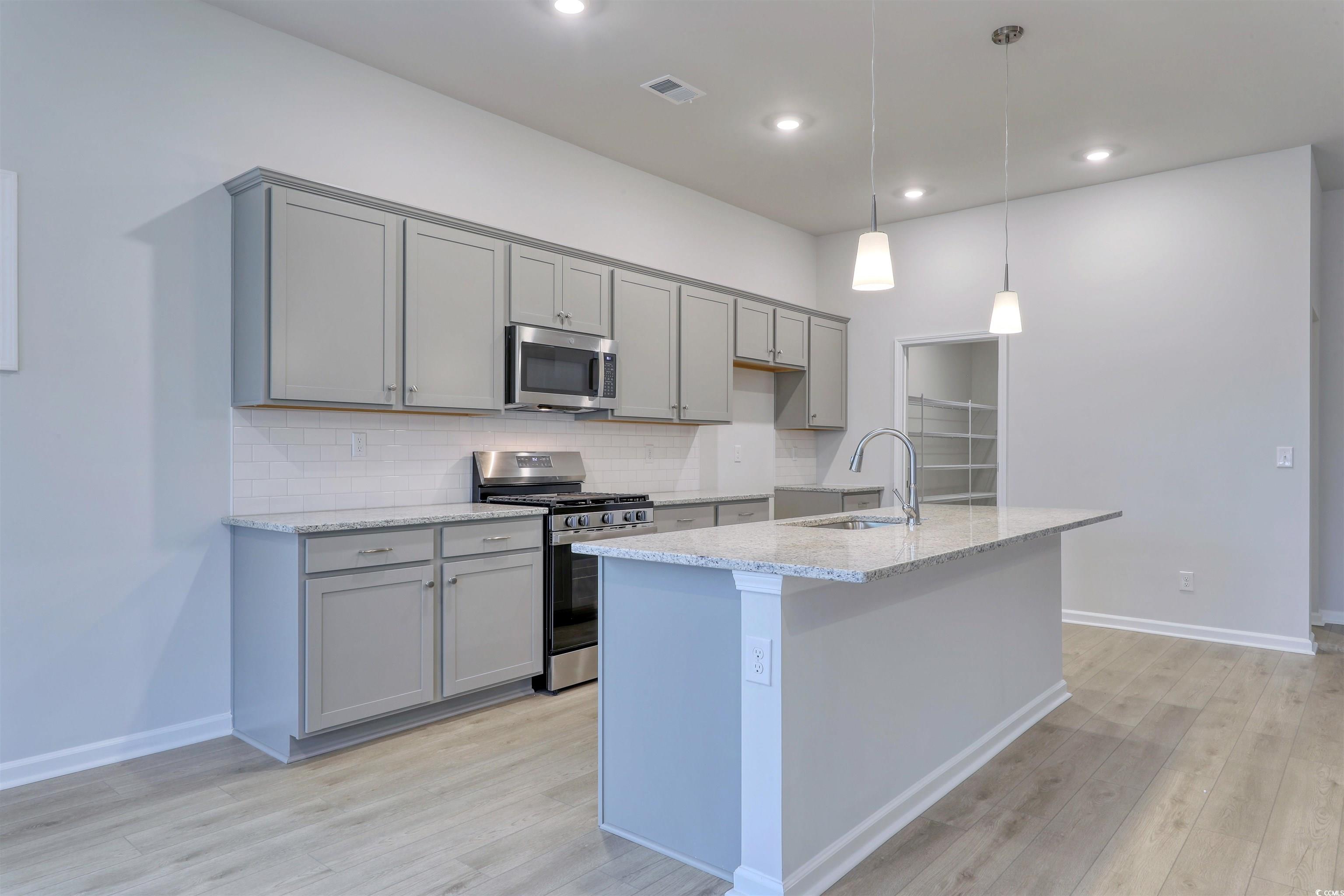 370 Garden Grove Street Conway, SC 29526 - Photo 5 of 28 Kitchen with gray cabinetry, appliances with stainless steel finishes, light stone counters, pendant lighting, and recessed lighting