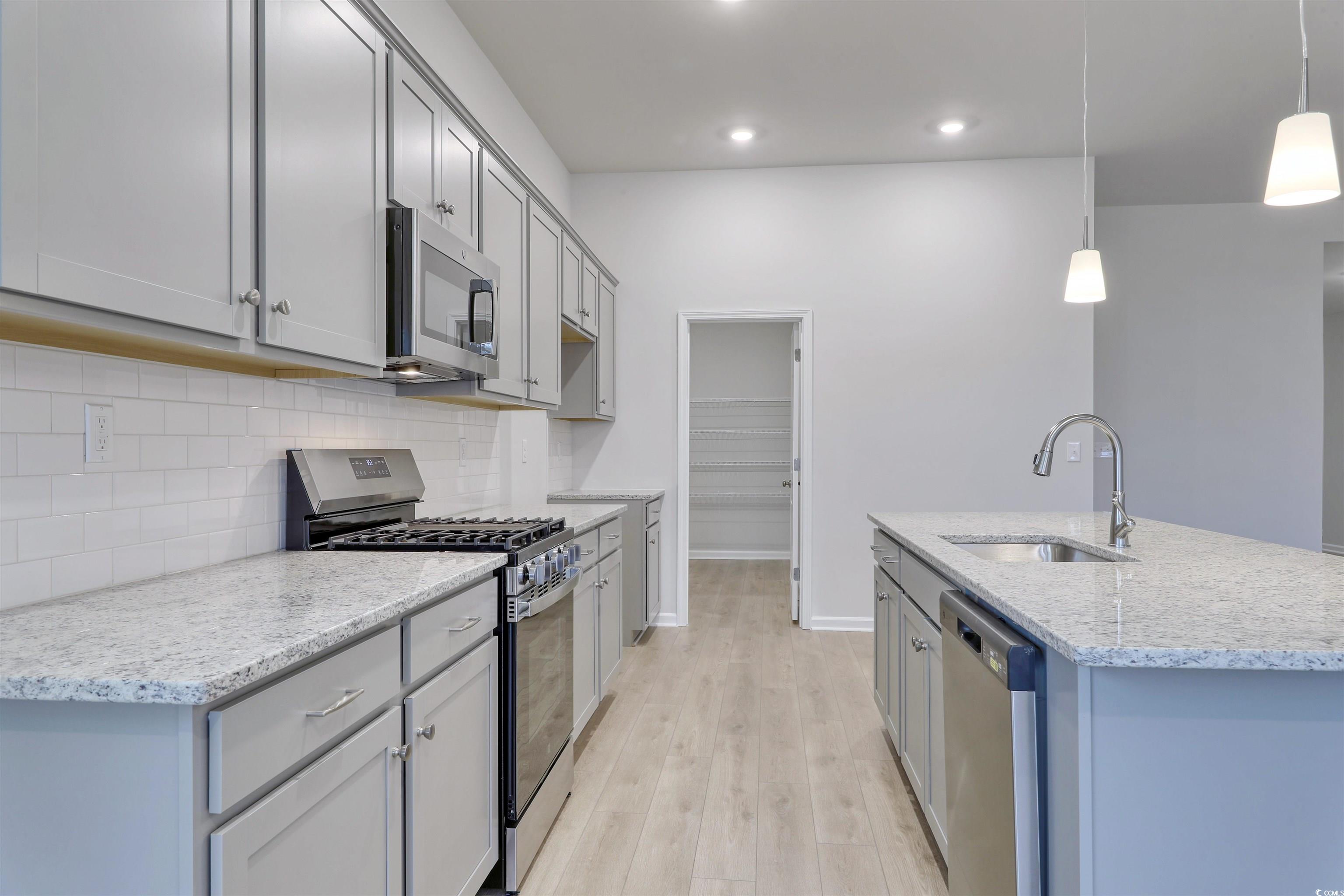 370 Garden Grove Street Conway, SC 29526 - Photo 6 of 28 Kitchen with stainless steel appliances, light stone counters, gray cabinets, hanging light fixtures, and light wood finished floors