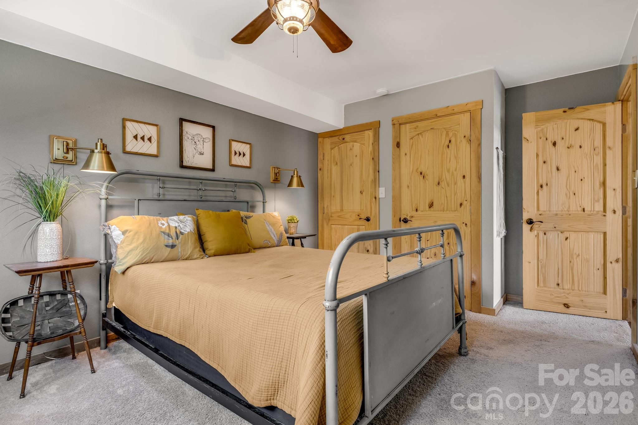 694 Boulder Road Marshall, NC 28753 - Photo 18 of 44 a bedroom with a bed and a chandelier