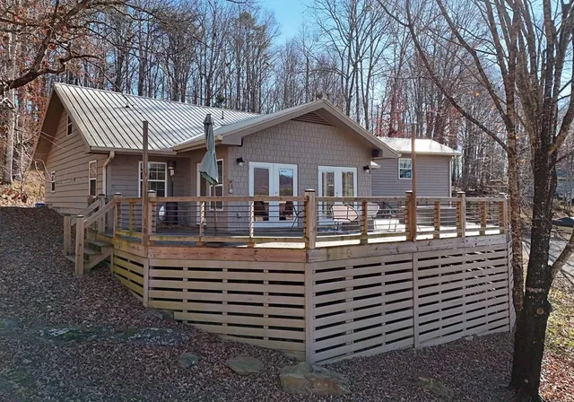 a front view of a house with a yard balcony and mountain view