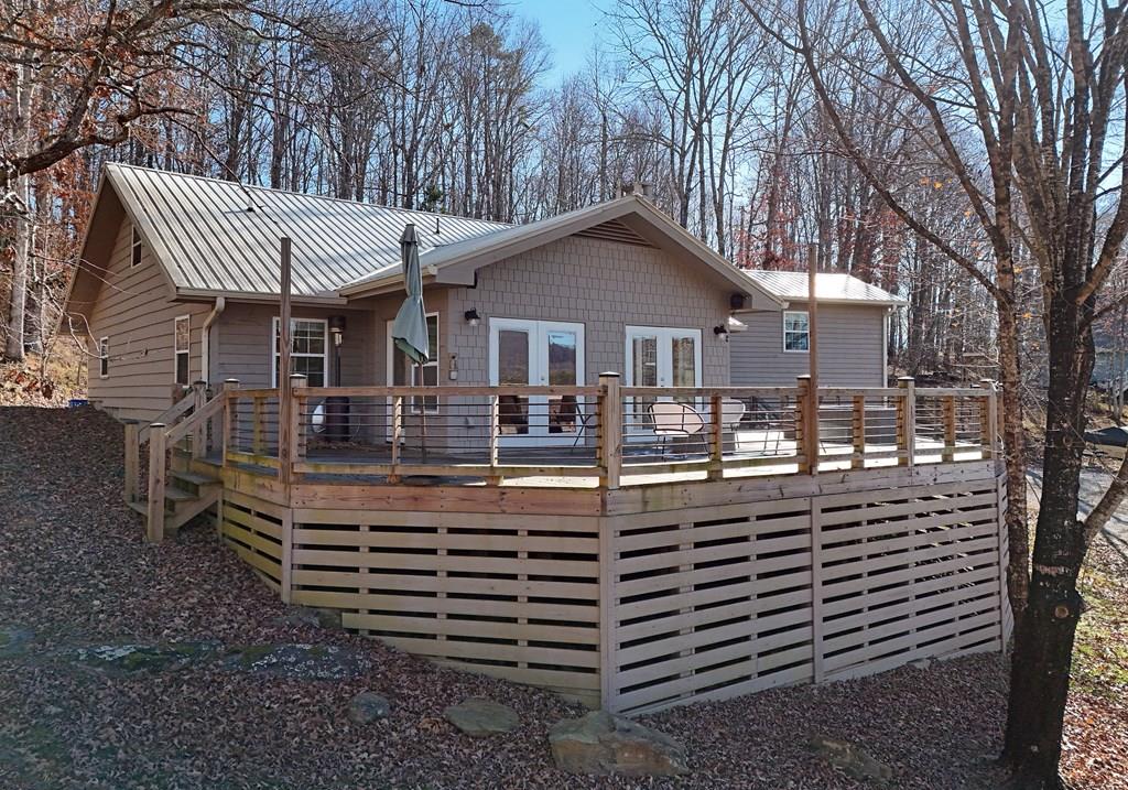 a front view of a house with a yard balcony and mountain view