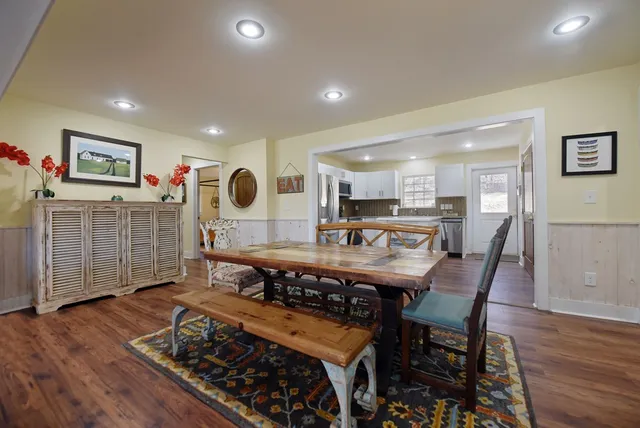 a dining room with furniture and wooden floor