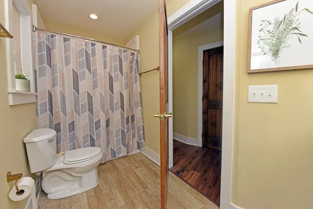 a bathroom with a toilet and a shower