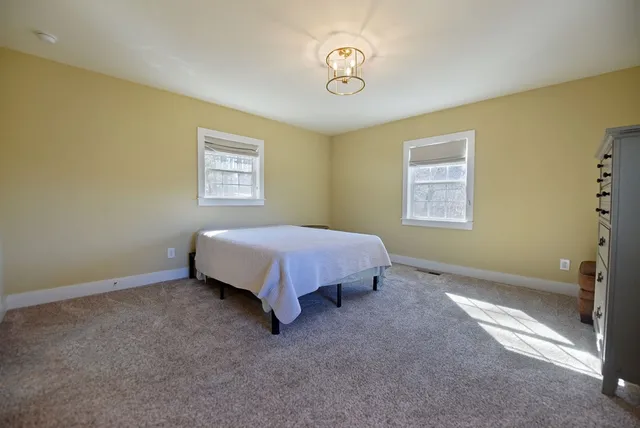 a spacious bedroom with a bed and a window