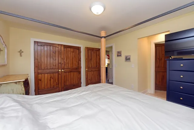 a bedroom with a bed and a dresser