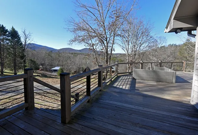 a view of a roof deck with wooden floor and fence