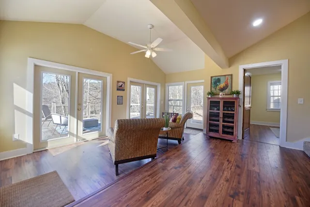 a living room with furniture and wooden floor