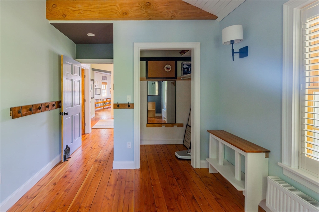 27 Maverick Street Marblehead, MA 01945 - Photo 14 of 31 a hallway with wooden floor stairs and a window