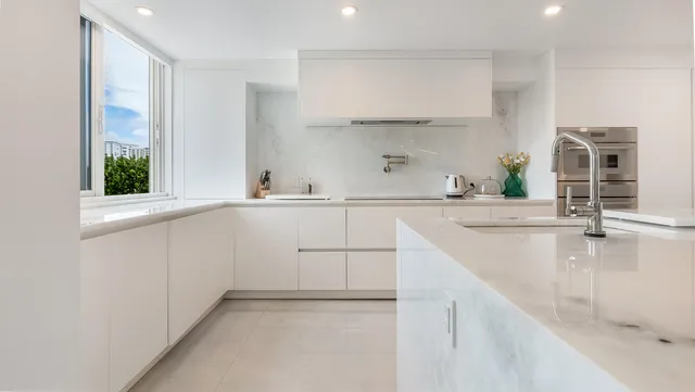a kitchen with a sink stove and cabinets