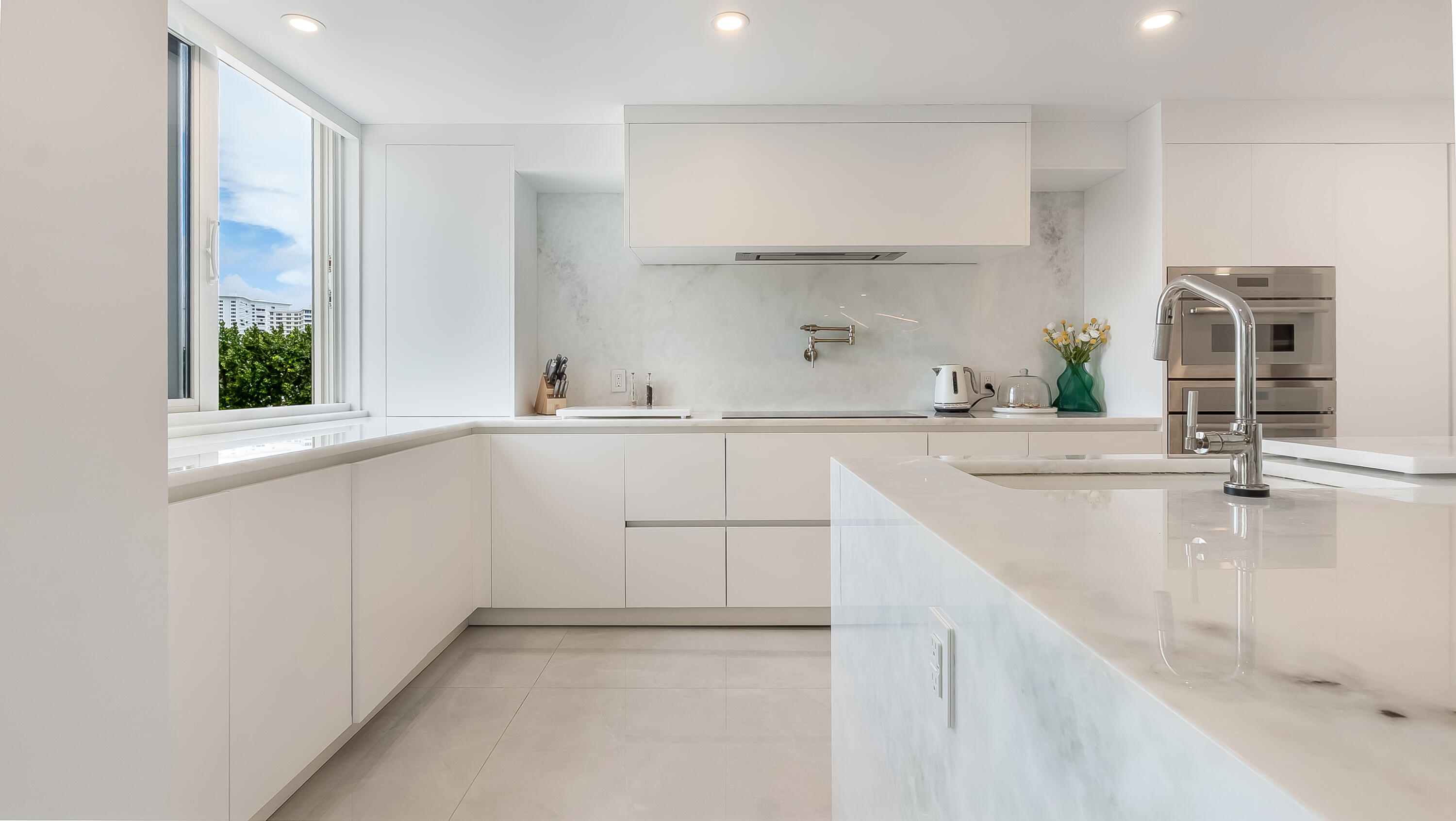 901 East Camino Real, Unit 2A Boca Raton, FL 33432 - Photo 11 of 30 a kitchen with a sink stove and cabinets