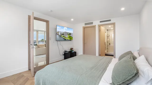 a bedroom with a bed and painting on the wall