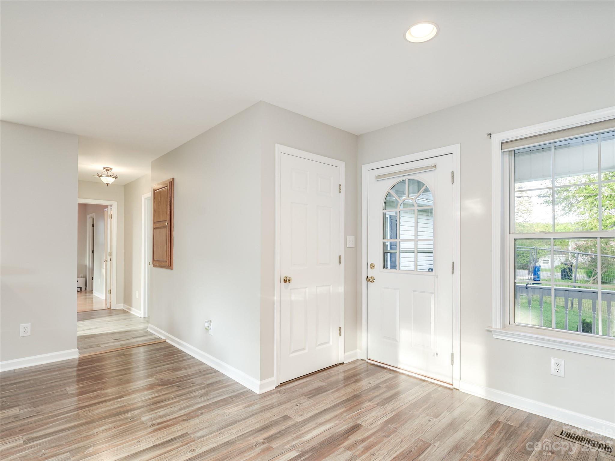 111 Hoyle Street Morganton, NC 28655 - Photo 6 of 30 a view of an empty room with wooden floor and a window