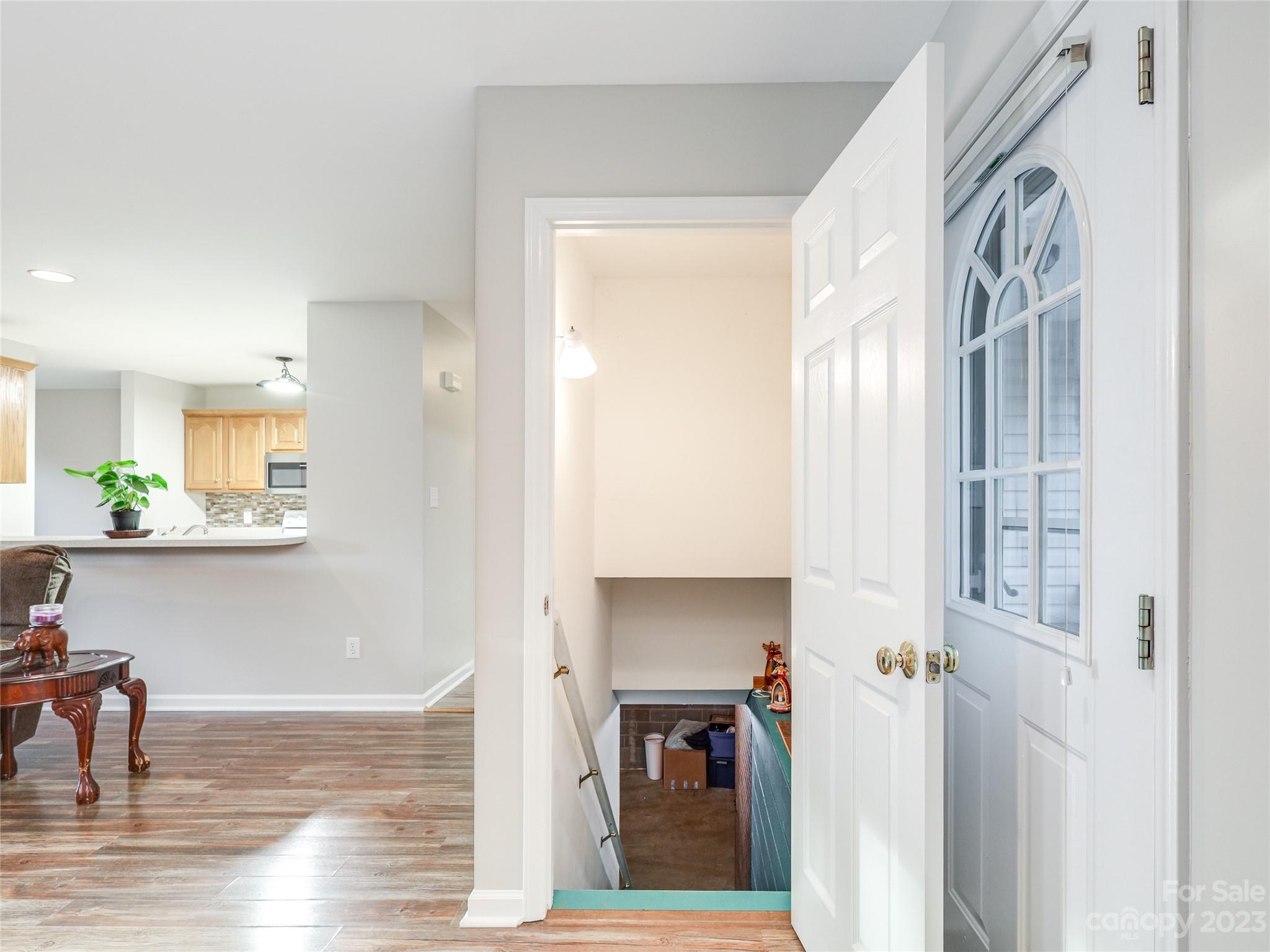 111 Hoyle Street Morganton, NC 28655 - Photo 7 of 30 a view of a hallway with wooden floor and a living room