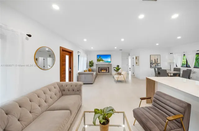 a living room with furniture a clock on wall and a table