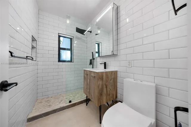 a bathroom with a toilet sink and shower