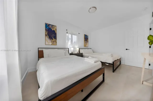 a bedroom with a bed and painting on the wall