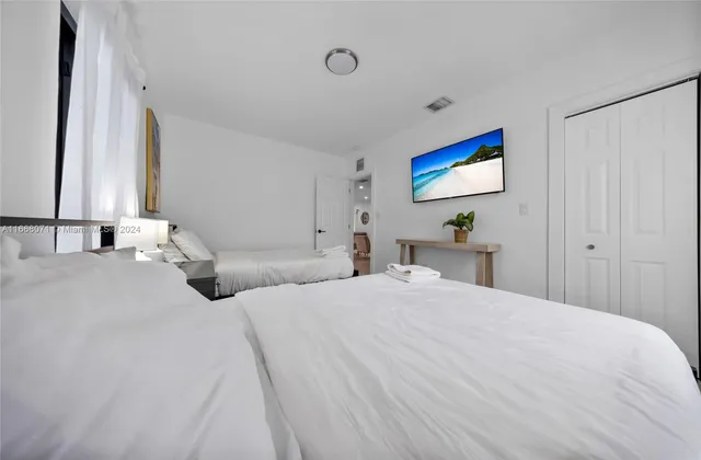 a bedroom with a bed and a painting on the wall