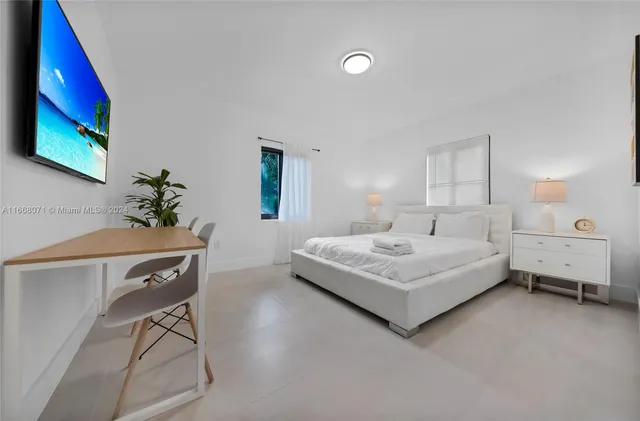 a bedroom with a bed and a chair