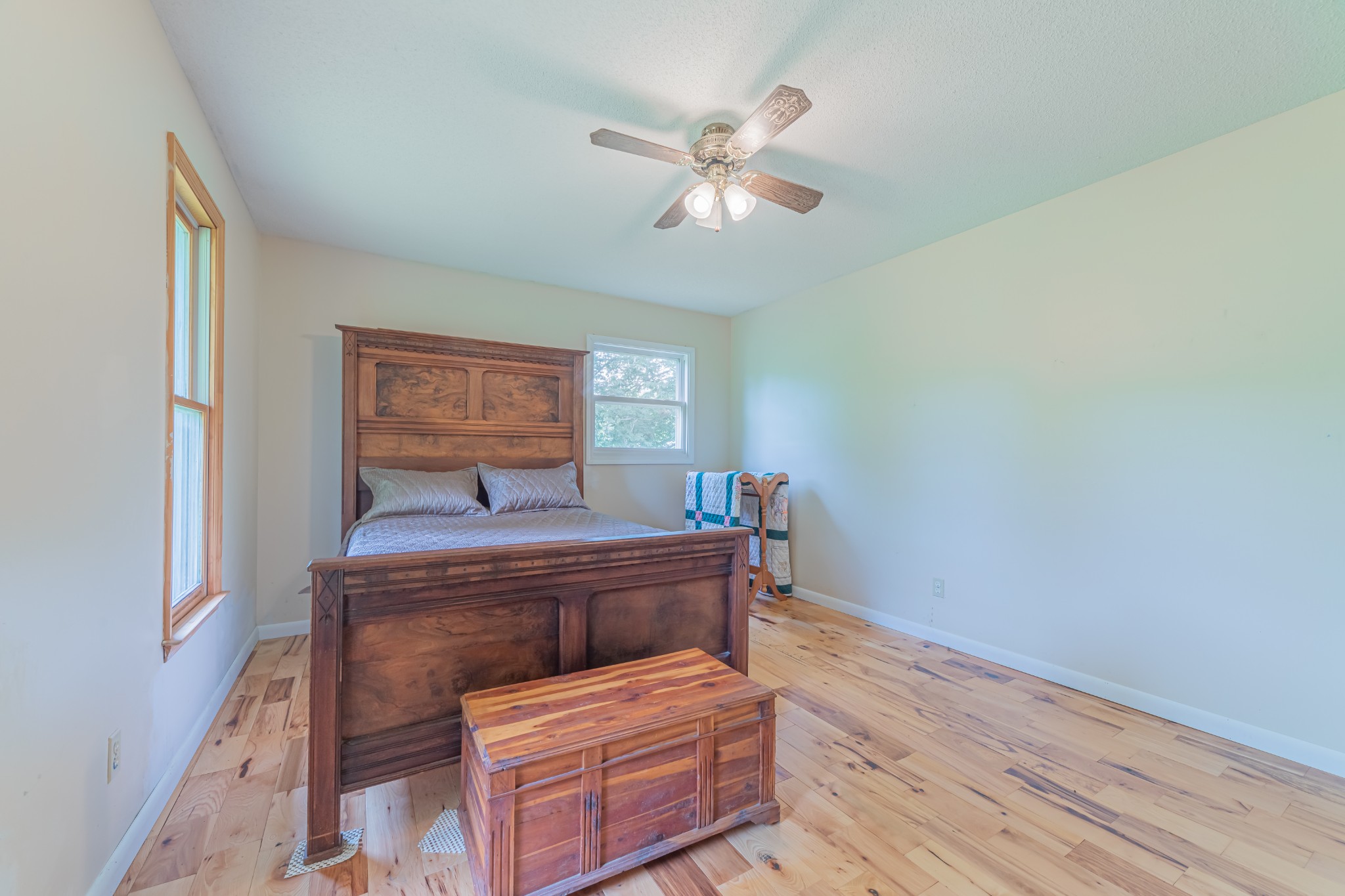 292 Laynes Cove Road Pelham, TN 37366 - Photo 22 of 43 a bedroom with a bed and a chandelier