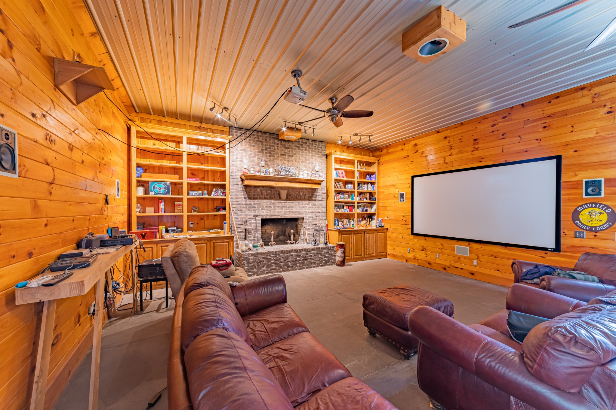 292 Laynes Cove Road Pelham, TN 37366 - Photo 40 of 43 a projector room with fireplace furniture and a ceiling fan