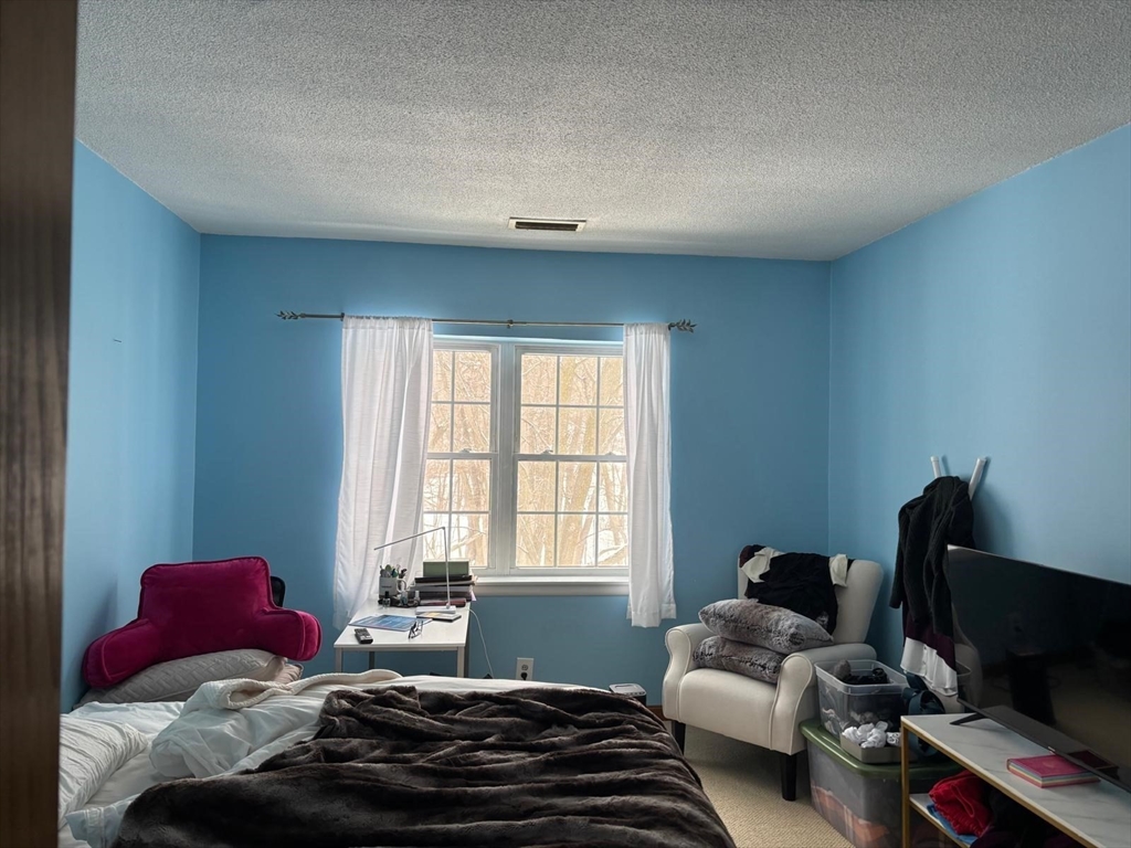 125 Lake Shore Road, Unit 4 Boston, MA 02135 - Photo 9 of 9 a bedroom with a bed and a window