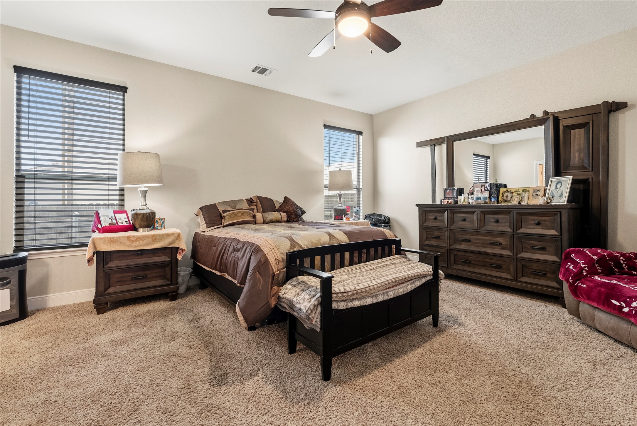 105 West Point Way Elgin, TX 78621 - Photo 8 of 27 Carpeted interior space featuring a ceiling fan with integrated lighting, multiple windows with blinds, and neutral wall tones