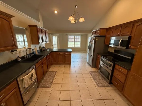 a kitchen with stainless steel appliances a sink stove and cabinets