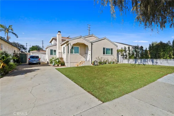 a front view of a house with a garden and yard