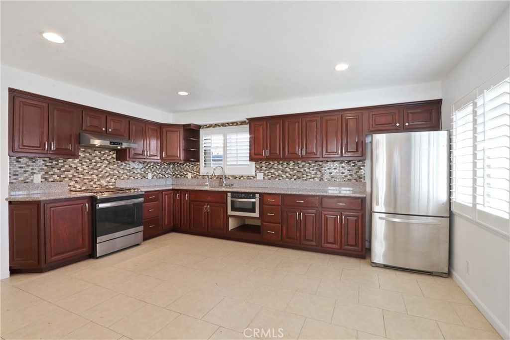 657 Wilber Place Montebello, CA 90640 - Photo 19 of 32 a kitchen with stainless steel appliances granite countertop a refrigerator sink and cabinets