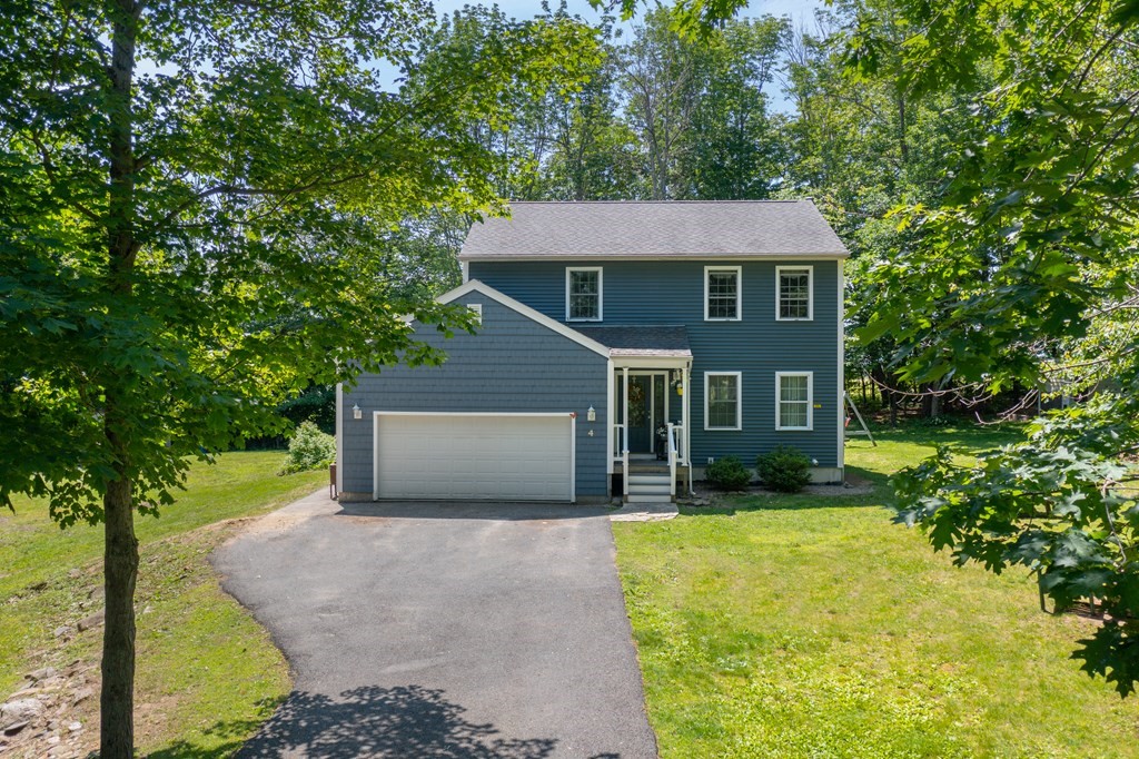 4 Huntington Road Blandford, MA 01008 - Photo 1 of 27 a front view of a house with a yard and garage