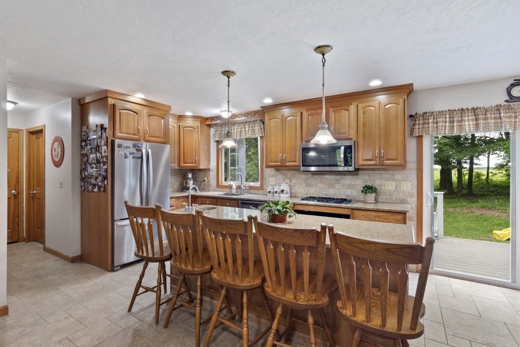 4 Huntington Road Blandford, MA 01008 - Photo 14 of 27 a kitchen with stainless steel appliances granite countertop a stove a refrigerator a kitchen island a sink and a cabinets