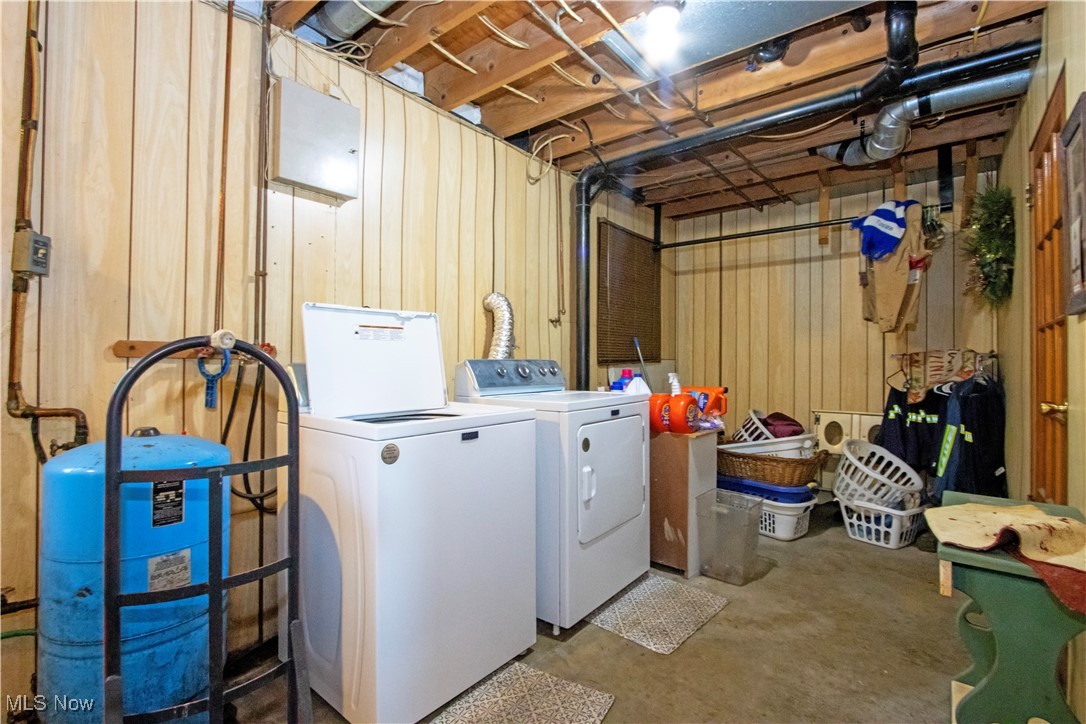 1292 Cinder Road Southeast Carrollton, OH 44615 - Photo 42 of 42 Laundry room with separate washer and dryer and wood walls