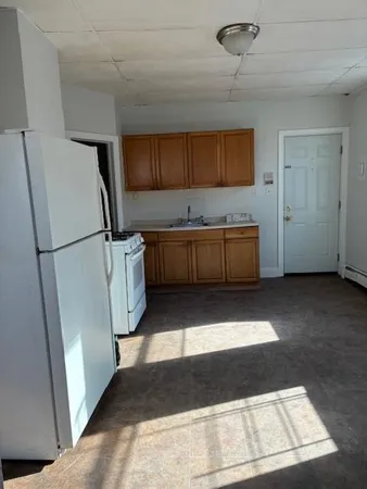 a kitchen with a refrigerator and a sink